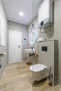 a bathroom with a toilet and a sink at Dora rooms and studios in Sutivan