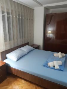a bedroom with a bed with two towels on it at IVAN Apartment in Peštani