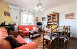 a living room with a couch and a table at Cortijo VILLA EL PINO in Torrox