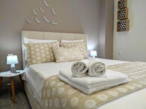 a bedroom with a bed with towels on it at Stamatia Apartments in Asprovalta