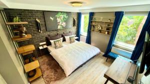 a bedroom with a bed and a brick wall at IQ Hotel Hannover in Hannover