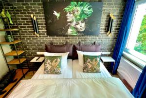 a bed in a room with a brick wall at IQ Hotel Hannover in Hannover