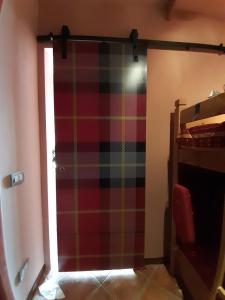 a plaid door in a room with a window at Prato Nevoso Borgo Stalle Lunghe con accesso diretto alle piste da sci in Prato Nevoso