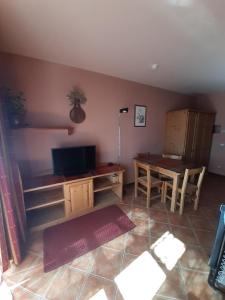 a living room with a table and a dining room at Prato Nevoso Borgo Stalle Lunghe con accesso diretto alle piste da sci in Prato Nevoso