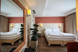 A bed or beds in a room at H2O ROOMS
