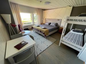 a small bedroom with a bed and a bunk bed at Vaibla Holiday Center in Vaibla