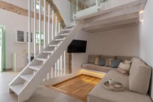 a living room with a staircase and a couch at Dipagio Origin Villa in Lachania
