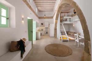 a kitchen and a living room with a spiral staircase at Dipagio Origin Villa in Lachania +33 photos