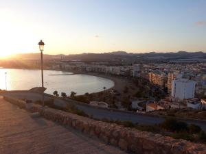 a view of a beach and a city at sunset at Casa Angelus in Águilas