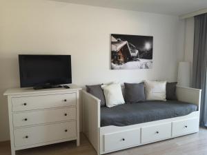 a bedroom with a bed and a tv and a dresser at Ferienwohnung Alpenspaß in Missen-Wilhams