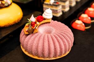 a pink cake with whipped cream and strawberries on top at The Palace Hotel, Sunny Day in St. St. Constantine and Helena