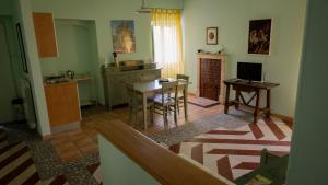 a living room with a table and a kitchen at La Via di Fuga in Pietrapertosa