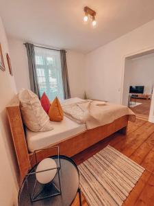 a bedroom with a large wooden bed with pillows at Boardinghouse alte Spinnerei in Offenburg