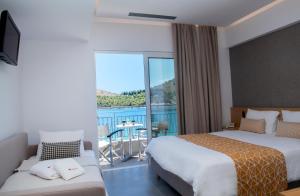 Postel nebo postele na pokoji v ubytování Minoa Hotel