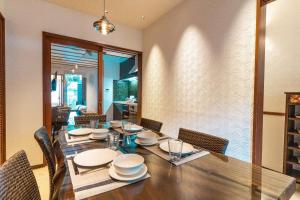 a dining room with a wooden table and chairs at Kyobu Higashiyama in Kyoto