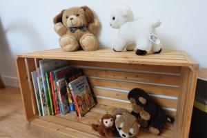 a group of stuffed animals sitting on a wooden shelf at Hotel Bären Guttannen in Guttannen
