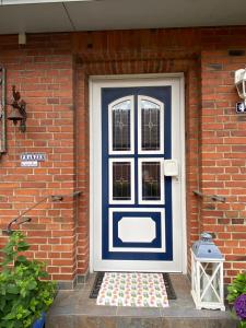a blue and white door on a brick house at Susewind in Bad Segeberg