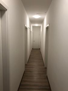 
an empty room with a door leading to a hallway at Omega Apartments Budapest in Budapest
