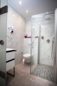 a bathroom with a glass shower with a toilet at Old Rubinum Apartment in Rovinj +34 photos