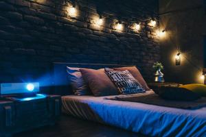 a bedroom with a bed with lights on it at Лофт студия с панорамной террасой in Mykolaiv
