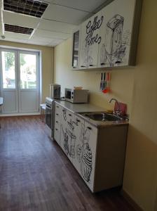 a kitchen with a counter with drawings on it at Комплекс центр развития туризма in Zlatoust