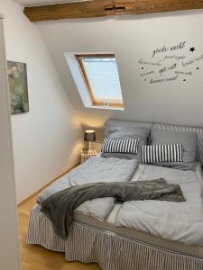 a bed in a room with aigraphy on the wall at FeWo Casa in Boizenburg