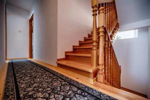 a staircase in a house with a rug at Komiza Provita Guesthouse in Komiža