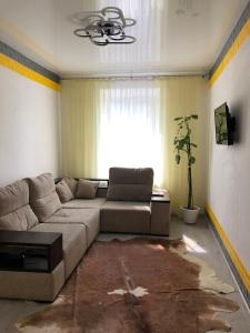 a living room with a couch and a window at Devolano 1 in Odesa