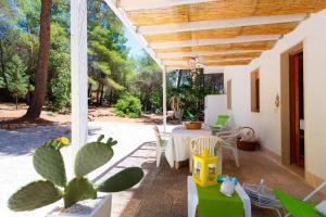 a patio with a table and chairs and a cactus at Gariga Holidays Apartments in Nardò