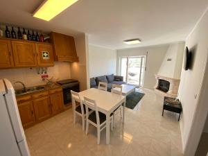 a kitchen and living room with a table and chairs at Casa Melli with Sunset Oceanview Terrace in Lourinhã