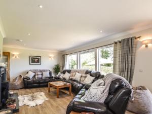 a living room with a couch and a table at Culreach Lodge in Grantown on Spey