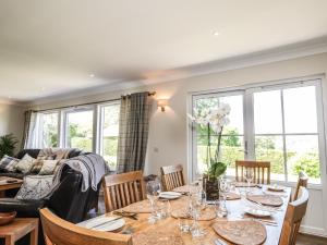 a dining room and living room with a table and chairs at Culreach Lodge in Grantown on Spey