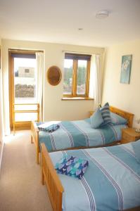 A bed or beds in a room at Ty Nant Cottages and Suites