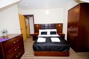 a hotel room with a bed and a desk at William's Hillsborough Apartments in Sheffield