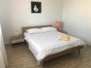 Postel nebo postele na pokoji v ubytování Apartmani Sanda i Leo