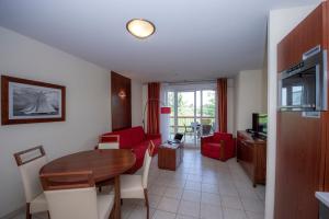 uma sala de estar com uma mesa de jantar e uma cozinha em Goélia Mandelieu Riviera Resort em Mandelieu-la-Napoule