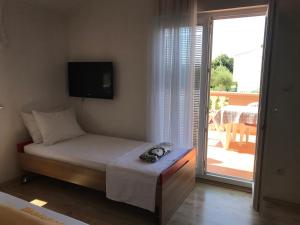 Postel nebo postele na pokoji v ubytování Apartmani Sanda i Leo
