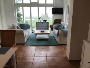 a living room with couches and a coffee table at Ferienhaus Grabowblick in Barth