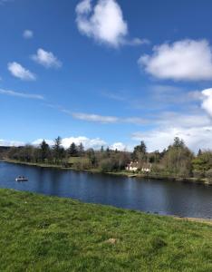 a lake with a boat in the water at Keenaghan Cottage Belleek Fermanagh Northern Ireland in Belleek