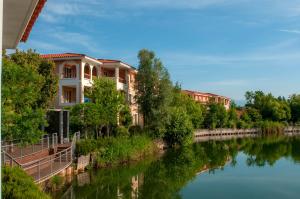 a row of houses next to a river at Goélia Mandelieu Riviera Resort in Mandelieu-La Napoule