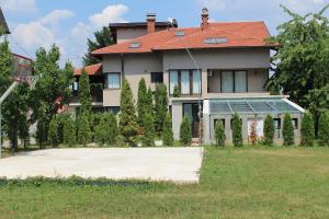 a large house with a yard in front of it at Villa Čengić in Sarajevo