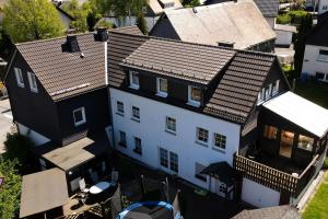 an overhead view of a white house with a roof at Ferienwohnung Greetje in Olsberg