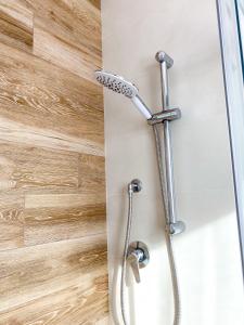 a shower with a shower head in a bathroom at La perla del Porto in Porto Recanati