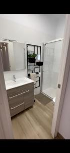 a bathroom with a sink and a mirror and a shower at Alojamiento La Colonia in Águilas