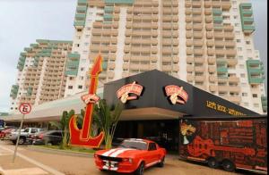 a red car parked in front of a building at ENJOY OLIMPIA PARK RESORT - Thermas dos Laranjais in Olímpia