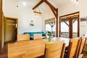 a dining room and living room with a table and chairs at Panorama House in Praid