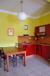 a kitchen with a wooden table and red cabinets at Festival in Karlovy Vary