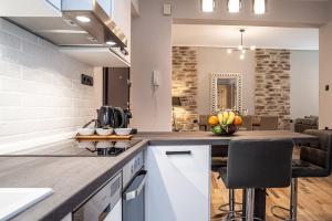 a kitchen with a counter with a bowl of fruit at Charissa apartment in Volos