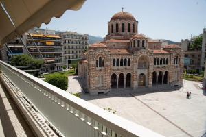 a large brick building with a tower on top of it at Charissa apartment in Volos