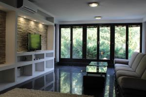 a living room with a couch and a television at Villa Čengić in Sarajevo